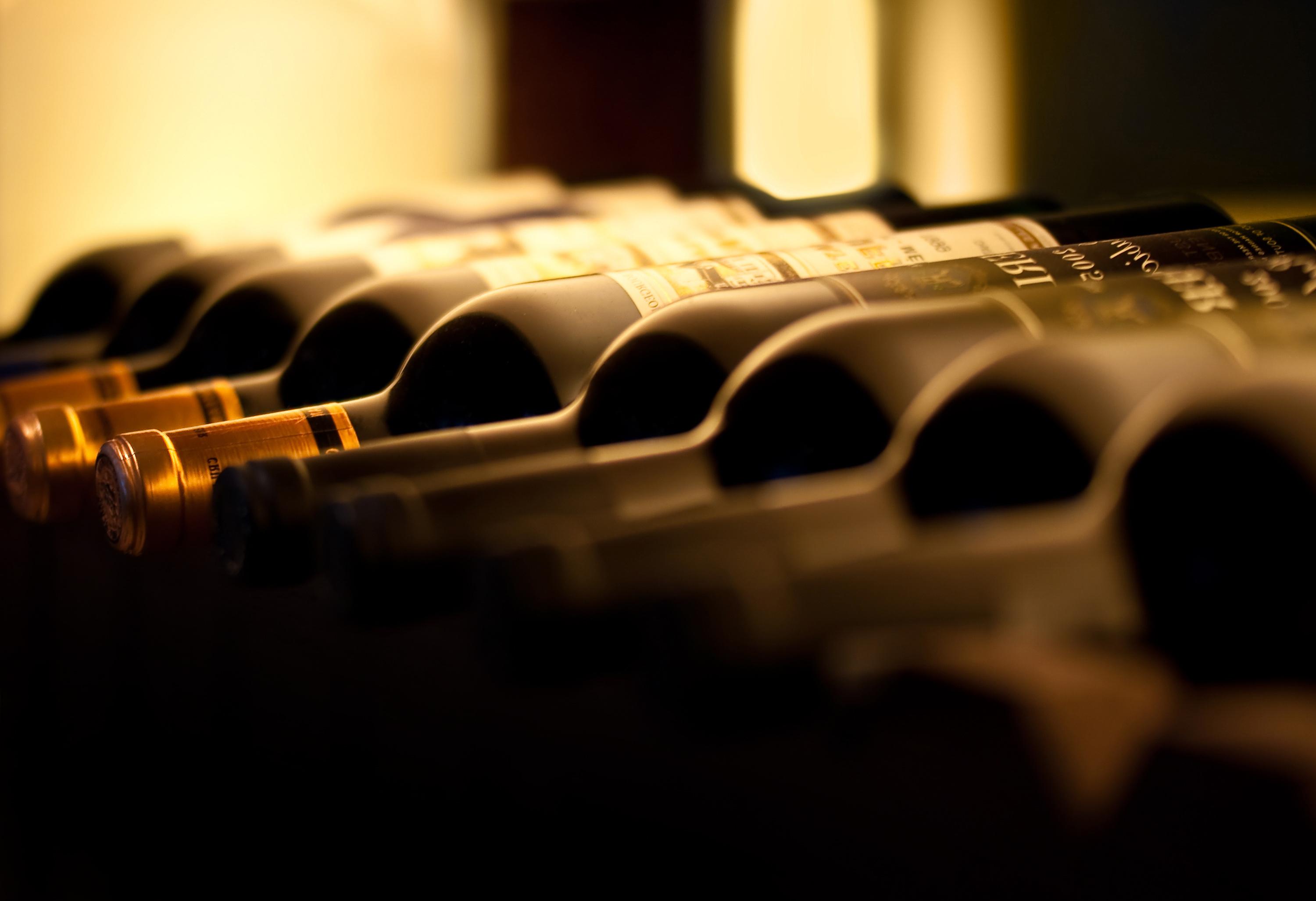 Wine bottles laid on their sides in a cellar rack
